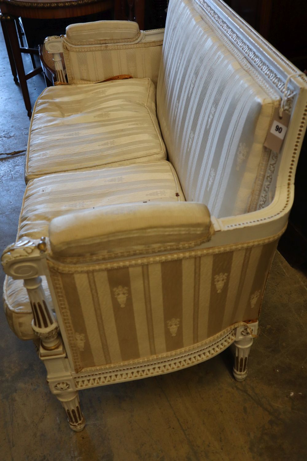 An early 20th century parcel gilt white painted canapé, width 128cm